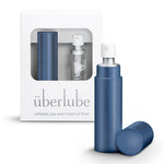 A navy-colored personal lubricant refillable case, with a 15ml glass insert of uberlube prominently displaying the überlube brand packaging and a capacity indicator at the bottom. — 14