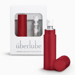 A red-colored personal lubricant refillable case, with a 15ml glass insert of uberlube prominently displaying the überlube brand packaging and a capacity indicator at the bottom. — 17