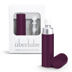 An eggplane-colored personal lubricant refillable case, with a 15ml glass insert of uberlube prominently displaying the überlube brand packaging and a capacity indicator at the bottom. — 21