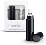 A black-colored personal lubricant refillable case, with a 15ml glass insert of uberlube prominently displaying the überlube brand packaging and a capacity indicator at the bottom. — 19